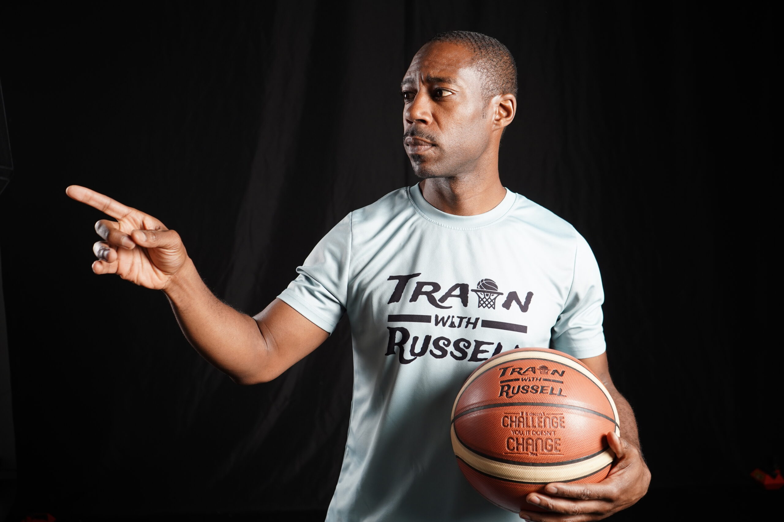 Coach Russell holding a basketball